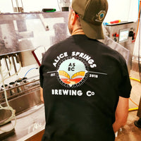 brewer at the alice springs brewery showing the back of the alice springs brewing co t-shirt